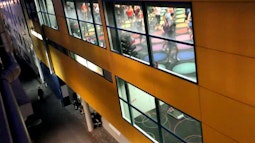 From an adjacent building people can be seen in a gym class.