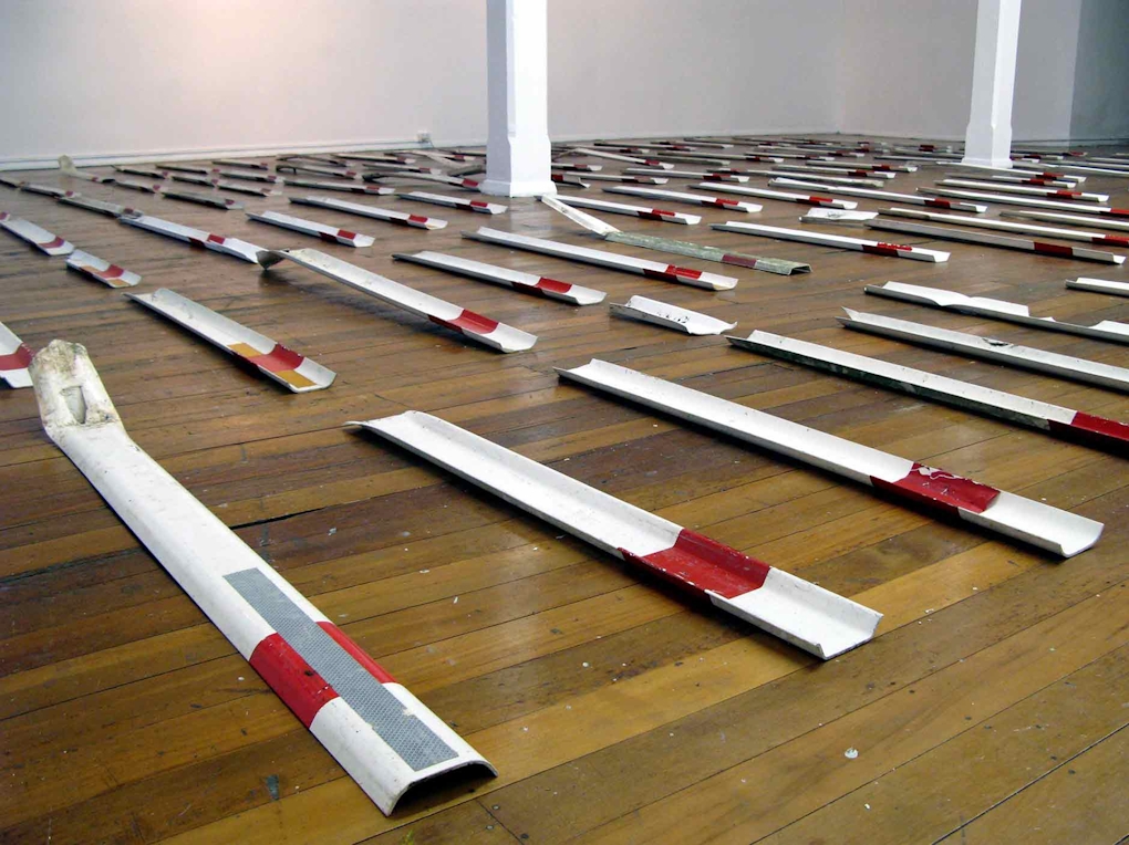 plastic white strips of plastic with red and reflective detail lie on the floor