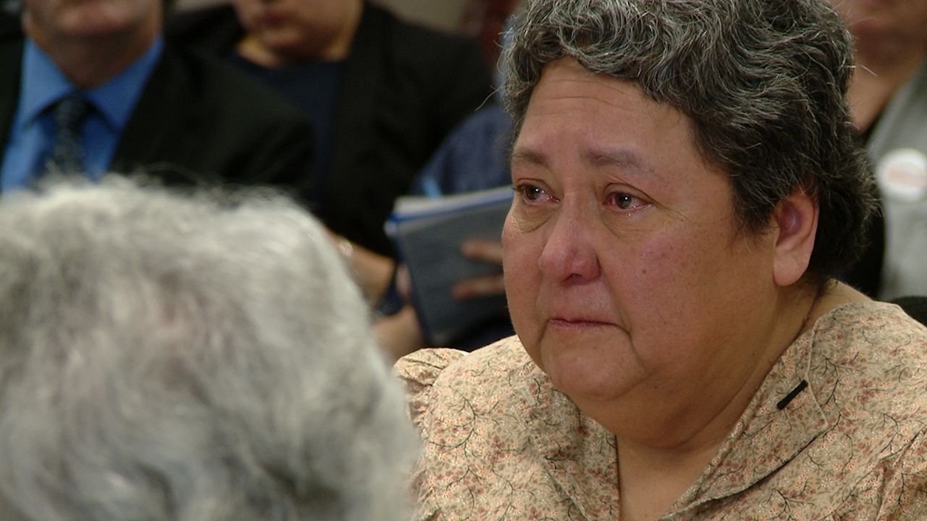 A tearful woman gives testimony in court.