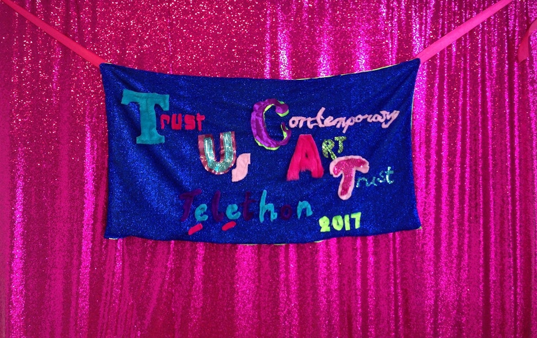 A handmade fabric sign reading "Trust Ss Contemporary Art Trust Telethon 2017"