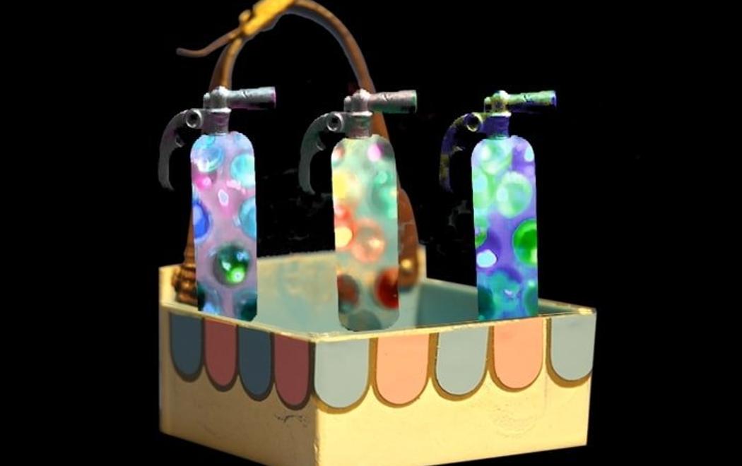 A mid-century concession stand box holds three gas cylinders which are full of colourful bubbles.
