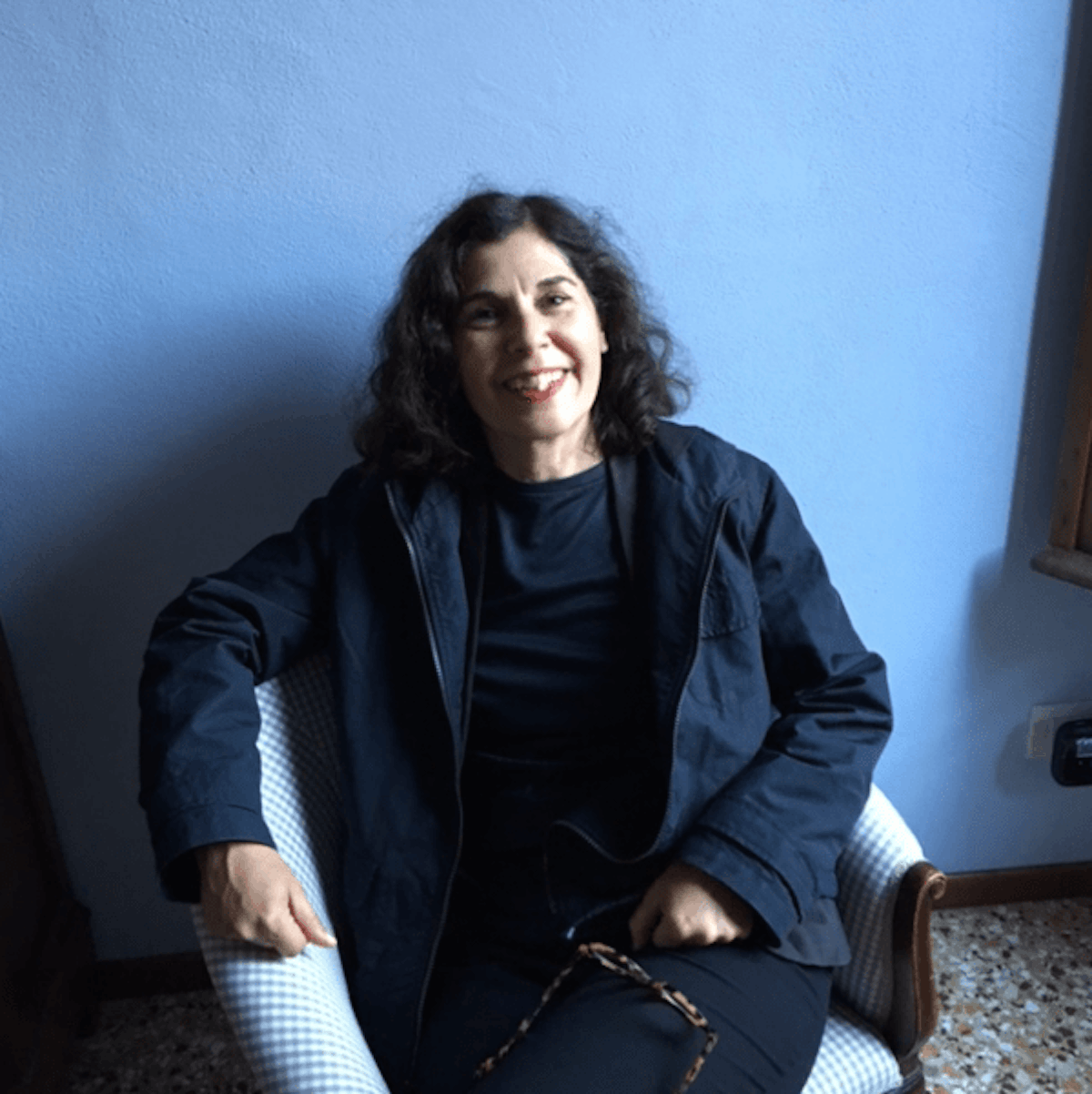 Mercedes Vicente smiling on a bright room with blue colours