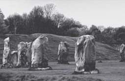 An old film photograph of large rocks standing in a public garden.