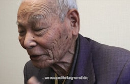 An elderly man has his eyes closed while talking, at the bottom is the text we escaped thinking we will die.