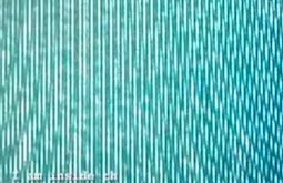 An extremely close up view of a TV screen, the pixels making abstract lines and patterns.