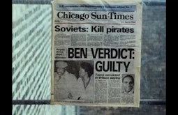 A Chicago Sun-Times newspaper is stuck against a window.