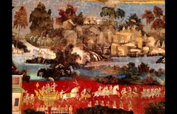 An antique painting of hills, trees, and rivers. There are figures of horses, armies and chariots.
