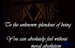 Dimly lit stained glass with digitally imposed words "To the unknown splendour of being, you can absolutely feel without moral absolutism, you know, you can absolutely do better than that, get tf down from there."