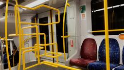 A digitally imposed yellow stainless steel bar winds its way around inside a train carriage.