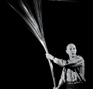 Len Lye holds a playful kinetic sculpture with his hands