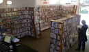 A person is browsing dvds in a video store in one of the last standing video stores in Aotearoa