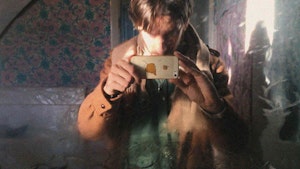 Martin takes a selfie in an old mirror with their iphone