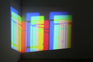 A shimmering projection of multi—coloured rectangles evoking windows hovering in the air