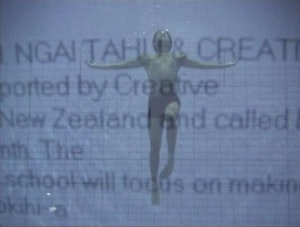 A photograph of a person underwater is overlaid obscured text which reads "NGA TAHU CREATIVE Supported by Creative New Zealand and called.. school with focus on making..."