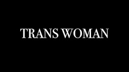 The tex 'TRANS WOMAN' is written in white across a black background.