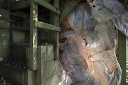 Biofilm, an eco plastic, is hung against wood under a deck