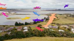 Multi-coloured animated sharks swim above an urban landscape.