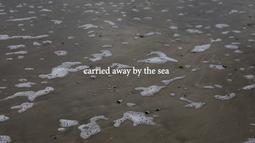 The shallow of edge of a wave with the words "carried away by the sea" written on screen.