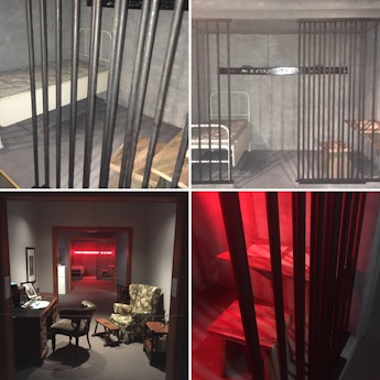 Shots of a mock jail cell and writing table sometimes bathed in intrusive red light