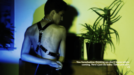 A person wearing a black body harness and chain looks over their shoulder in a sultry manner, text overliad onto the image reads "You foreshadow thinking we don't know whats coming. Vers's just do baby. That Takes practice. -VS"