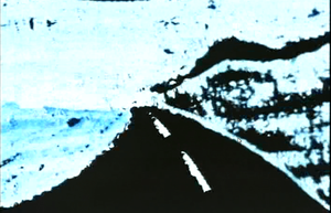 Travelling down the highways that carve through the unpeopled wilderness of New Zealand's South Island, we see a dark road in an animated movie which has been made by painting directly onto film.
