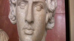 A close up of a stone statue's face.