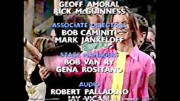 David bowie smiles at the camera from amongst a group of people as credits roll over the top.