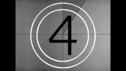 An old film reel countdown, the number four is centred in the frame with 2 white concentric circles around it.