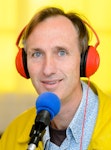 A person wearing red headphone with a bright yellow background