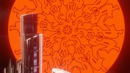 CGI glass buildings are haloed by a giant orange sun which is imprinted with baroque style graphics.
