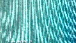 An extremely close up view of a TV screen, the pixels making abstract lines and patterns.