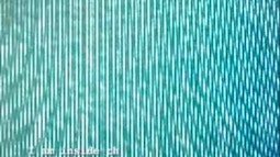 An extremely close up view of a TV screen, the pixels making abstract lines and patterns.