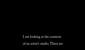text reads: I am looking at the contents of an artist's studio. There are..