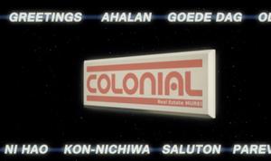 In this still of Bronwyn Holloway-Smiths work there is a digital spinning real estate sign reading “COLONIAL”. The image feels like an advertisement and has greetings in multiple languages above and below the spinning sign.