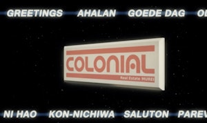 In this still of Bronwyn Holloway-Smiths work there is a digital spinning real estate sign reading “COLONIAL”. The image feels like an advertisement and has greetings in multiple languages above and below the spinning sign.