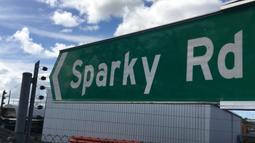 A large location sign reading 'Sparky Rd' that points to the left.