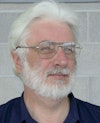 Dirk de Bruyn with white hair, white beard and glasses, smiling