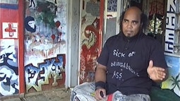 David Ezekiel sits in a heavily painted room talking.