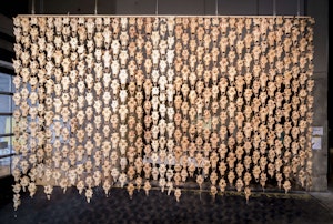 A curtain made of skulls drip down from the ceiling