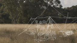 A dry grassy field with large green trees in the distance. An outline drawing in white of a group of people and a tent is super-imposed.