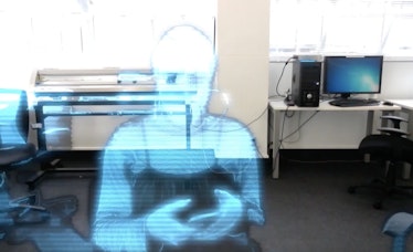 In a digital studio a ghostly blue image of a person appears to type on their phone