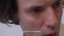 A close up of a face with text "A basic lie of language"