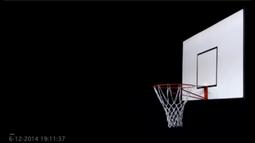 A white basketball back-board floats amongst a black background.