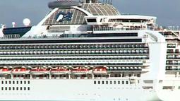A large cruise ship floats past.