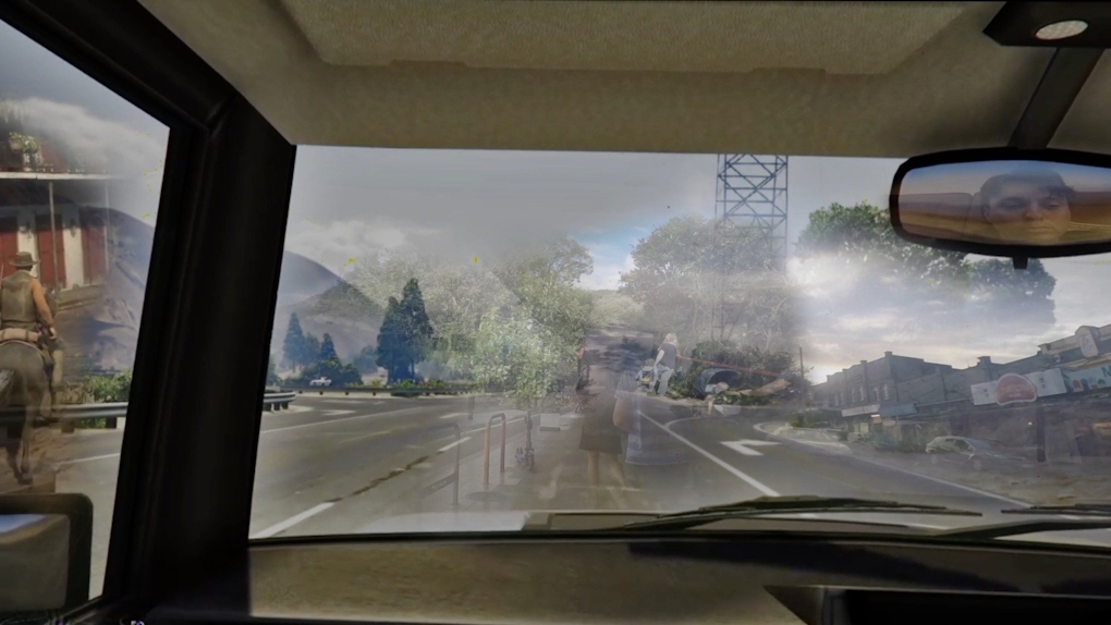 From inside a car we see a mixed reality animated scene; at left a cowboy, in the centre and right fragments of an urban shopping and road scene, plus unnaturally close trees. IN the top right we the face of a the artist as if they are playing a game and we are watching them