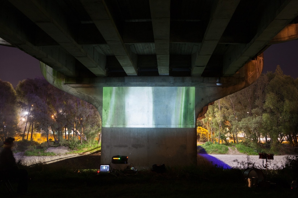A video projection under a bridge at night