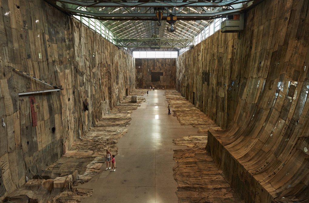 A extremely large gallery or concrete hall covered with beige skin-like fabric