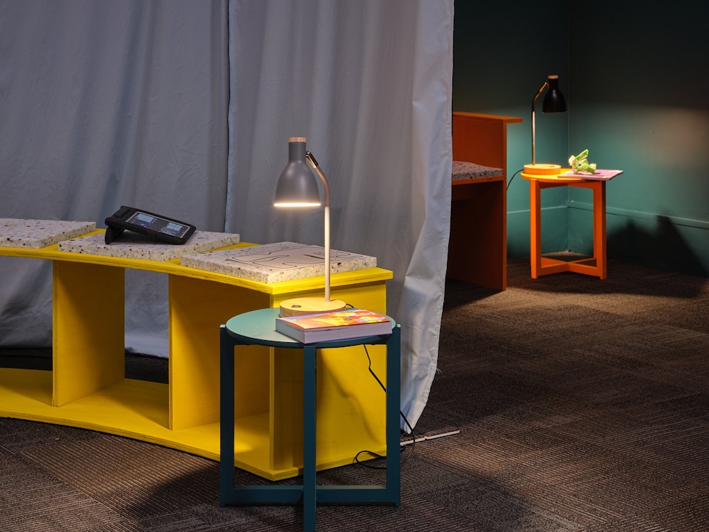 A colourful reading space with table lamps and stools