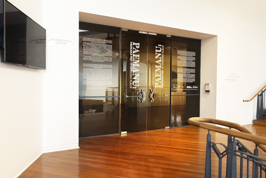 Glass doors with vinyl text applied onto them reading PAEMANU