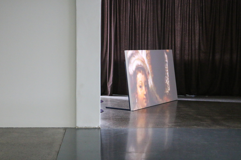 A portrait of an aristocrat is shown on a video screen